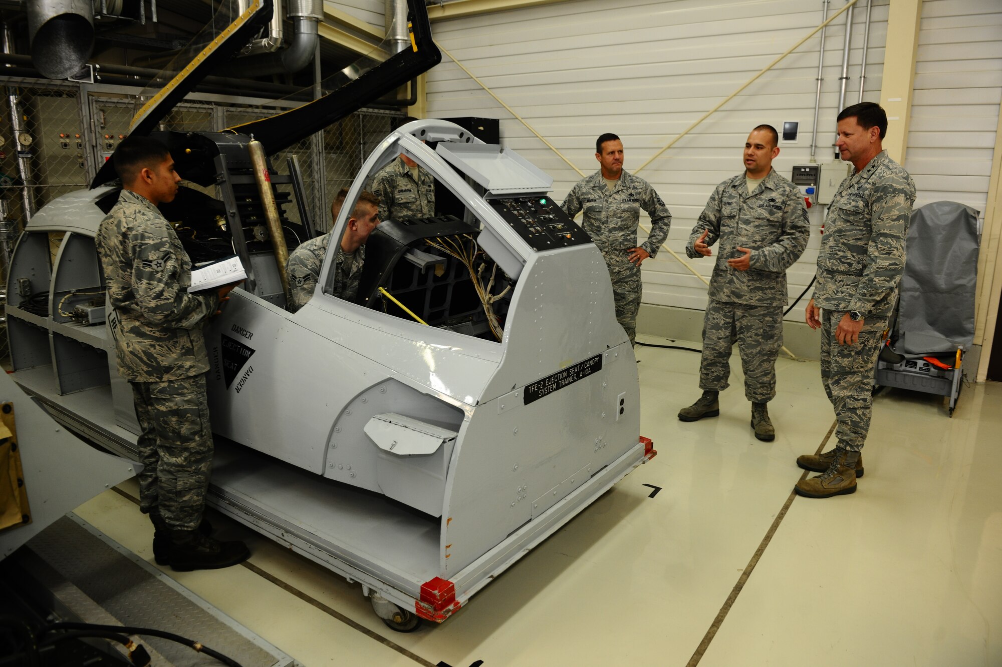 SPANGDAHLEM AIR BASE, Germany – Airmen assigned to the 52nd Aircraft Maintenance Squadron learn about A-10 Thunderbolt II manual canopy release methods while Chief Master Sgt. Oscar Mackin, 2nd Air Force command chief, and Maj. Gen. Leonard Patrick, 2nd AF commander, observe the training course during a tour of 372nd Training Squadron Detachment 2 classrooms and training facilities inside Bldg. 43 here April 18. Patrick and Mackin visited the 372nd TRS Det 2 during their 2nd AF overseas units tour. The detachment offers advanced skills using classroom and hands-on training on the F-16 Fighting Falcon and A-10 Thunderbolt II for more than eight different aircraft maintenance career fields. (U.S. Air Force photo by Airman 1st Class Dillon Davis/Released)