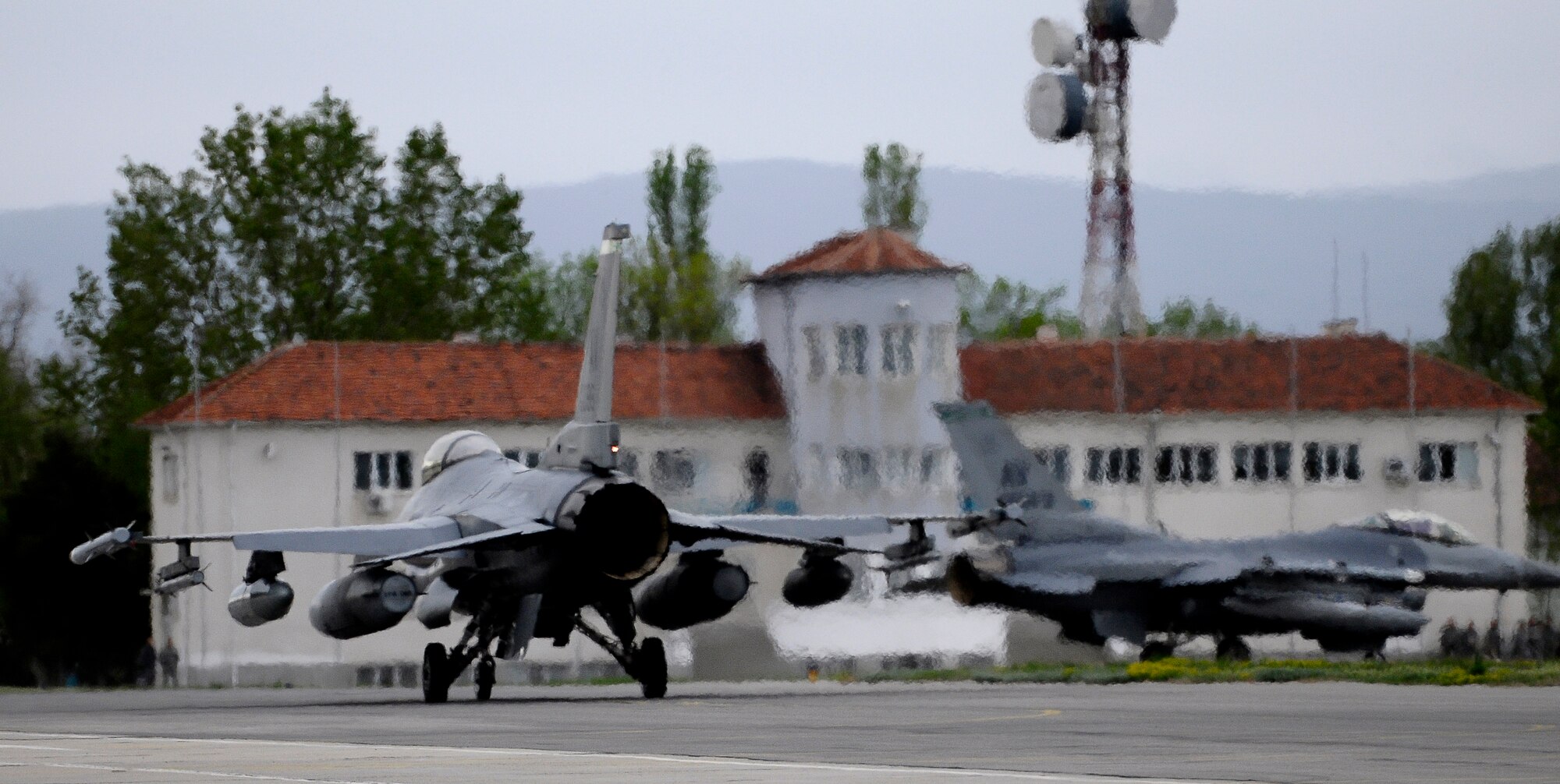 GRAF IGNATIEVO AIR FORCE BASE, Bulgaria -- Two 555th Fighter Squadron F-16 pilots taxi their jets down the runway April 17, 2012 after arriving from Aviano Air Base, Italy. More than two dozen aircraft and 500 U.S. Airmen from the 31st Fighter Wing at Aviano AB are taking part in Thracian Star 2012, a month-long joint training exercise focused on building partnerships and increasing interoperability with the Bulgarian air force. This is the third time since 2007 that men and women from the 31st FW have conducted this type of training with the Bulgarians. (U.S. Air Force photo/Senior Airman Katherine Windish)