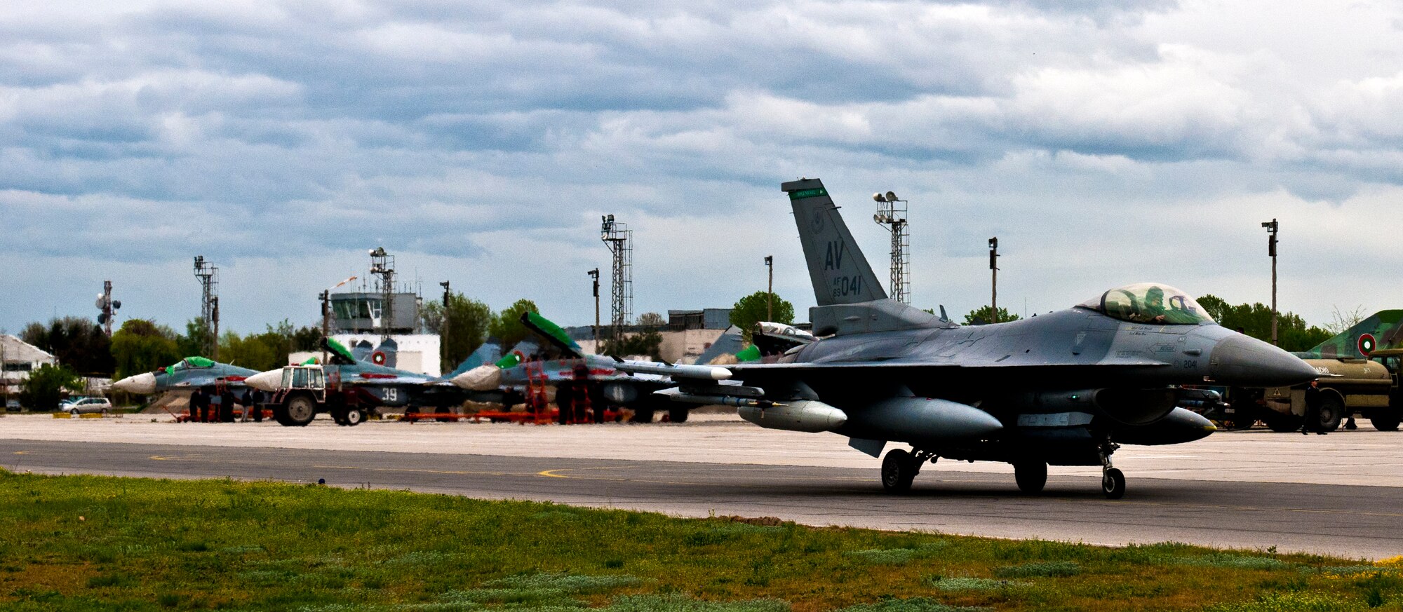 GRAF IGNATIEVO AIR FORCE BASE, Bulgaria -- A 555th Fighter Squadron F-16 pilot taxis past a line of Bulgarian air force MiG-21 and MiG-29 aircraft April 17, 2012 after arriving from Aviano Air Base, Italy. More than two dozen aircraft and 500 U.S. Airmen from the 31st Fighter Wing at Aviano AB are taking part in Thracian Star 2012, a month-long joint training exercise focused on building partnerships and increasing interoperability with the Bulgarian air force. This is the third time since 2007 that men and women from the 31st FW have conducted this type of training with the Bulgarians. (U.S. Air Force photo/Senior Airman Katherine Windish)