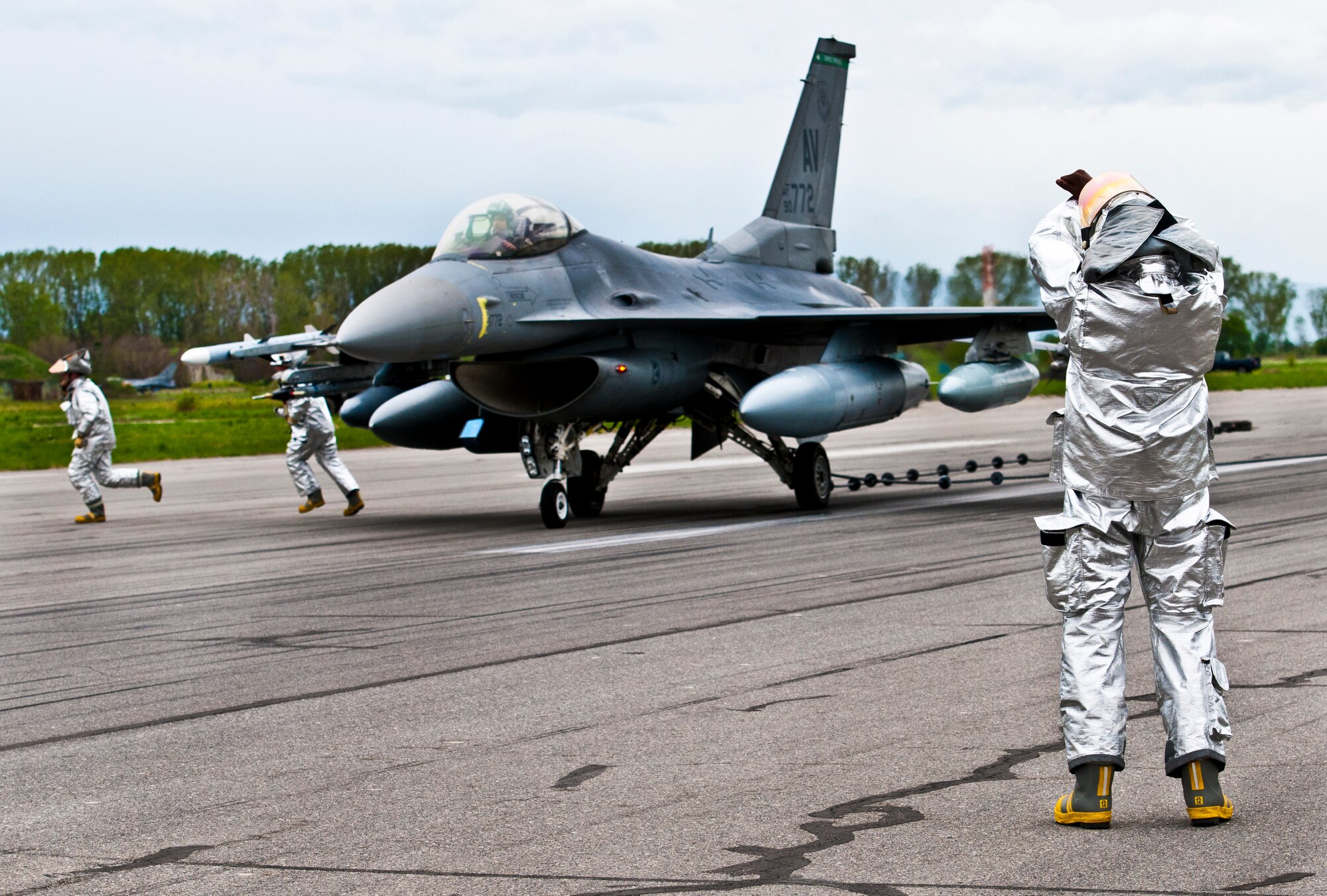 GRAF IGNATIEVO AIR FORCE BASE, Bulgaria -- Tech. Sgt. Brent Watkins, Airman Gage Boardingham and Airman 1st Class Corey Loesch, 31st Civil Engineer Squadron firefighters, test a barrier engagement on an F-16 after landing here April 17, 2012. Graf Ignatievo is now host to more than two dozen F-16 Fighting Falcons and more than 500 U.S. Air Force personnel in support of Thracian Star 2012, a month-long joint training exercise focused on building partnerships and increasing interoperability with the Bulgarian pilots, maintainers, joint terminal air controllers, firefighters and security forces Airmen. (U.S. Air Force photo/Senior Airman Katherine Windish)
