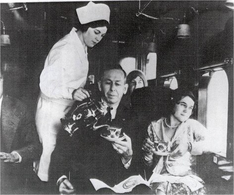 A stewardess serves a passenger on a flight in the early days of the stewardess program in Cheyenne, Wyo. (Image courtesty of Wyoming State Archives) 
