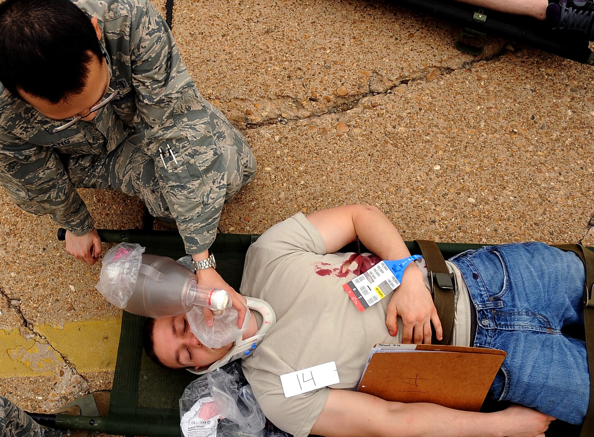 An Airman from the 2nd Medical Group tends to a simulated victim during a Major Accident Response Exercise on Barksdale Air Force Base, La, April 13. Several base agencies participated in the MARE to practice emergency response procedures prior to the upcoming base air show. (U.S. Air Force photo/Staff Sgt. Amber Ashcraft) (RELEASED)