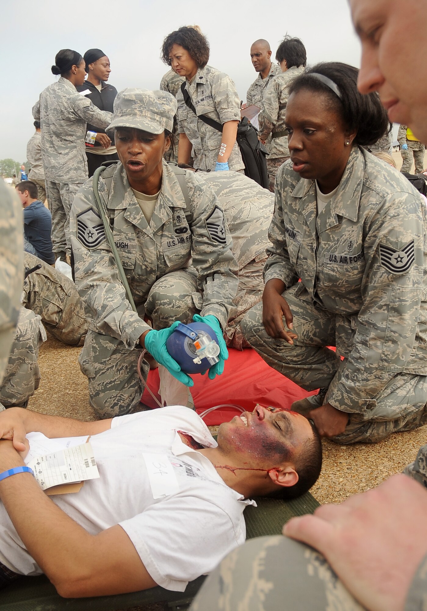 Airmen from the 2nd Medical Group tend to a simulated victim during a Major Accident Response Exercise on Barksdale Air Force Base, La, April 13. Several base agencies participated in the MARE to practice emergency response procedures prior to the upcoming base air show. (U.S. Air Force photo/Staff Sgt. Amber Ashcraft) (RELEASED)