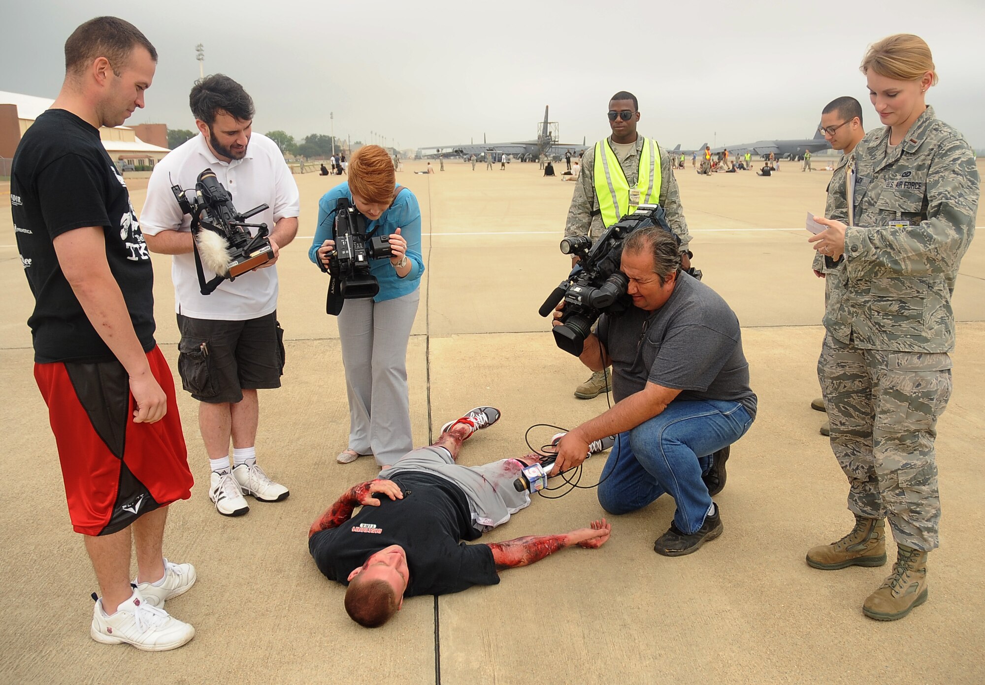 Local media interview a simulated victim prior to the start of a Major Accident Response Exercise on Barksdale Air Force Base, La., April 13. The exercise was held in preparation for any emergencies that may be encountered during an air show, evaluating several base and community emergency services and their level of response. (U.S. Air Force photo/Staff Sgt. Amber Ashcraft) (RELEASED)