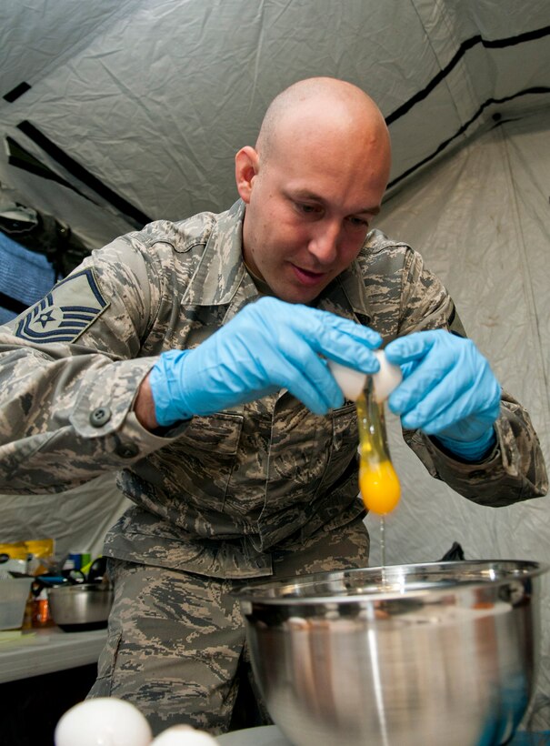 Master Sgt. Kyle A. Mack from the 208th Weather Flight of the Minnesota Air National Guard breaks eggs into a bowl in preparation for making pancakes from scratch for 208th Airmen.  Sixteen members of the 208th along with three U.S. Marines from the Marine Wing Support Squadron 471 US Naval- Marine Corps Reserve Readiness Center Minneapolis are taking part in a field training exercise at William O’Brien State Park on the St. Croix River in Minnesota Apr. 14, 2012. USAF photo by Tech. Sgt. Erik Gudmundson