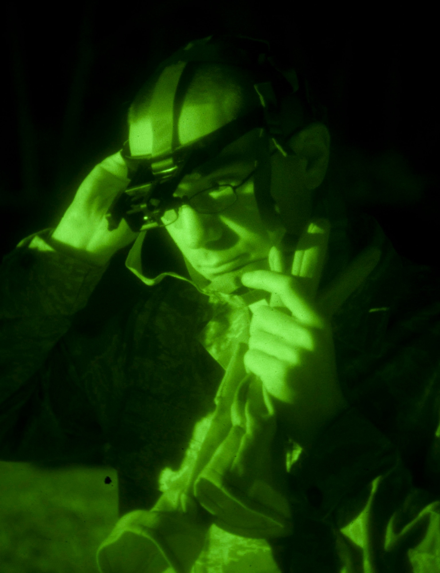 Senior Airman Christopher Church from the 208th Weather Flight of the Minnesota Air National Guard secures a night vision headset prior to beginning night vision training. Sixteen members of the 208th along with three U.S. Marines from the Marine Wing Support Squadron 471 US Naval- Marine Corps Reserve Readiness Center Minneapolis are taking part in a field training exercise at William O’Brien State Park on the St. Croix River in Minnesota Apr. 13, 2012. USAF photo by Tech. Sgt. Erik Gudmundson
