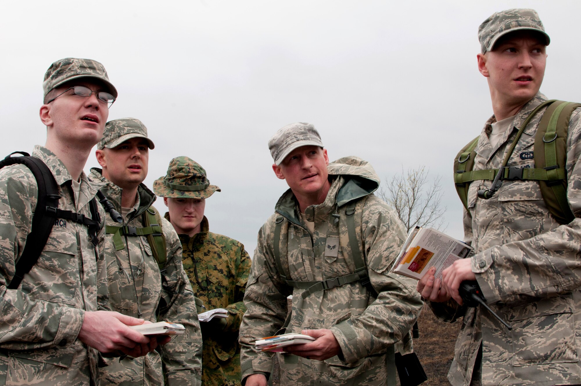 Airmen with the 208th Weather Flight of the Minnesota Air National Guard consult their Airman’s Manual to confirm the presence of simulated unexploded ordnance from a safe distance. Sixteen members of the 208th along with three U.S. Marines from the Marine Wing Support Squadron 471 US Naval- Marine Corps Reserve Readiness Center are taking part in a field training exercise at William O’Brien State Park on the St. Croix River in Minnesota Apr. 13, 2012. USAF photo by Tech. Sgt. Erik Gudmundson
