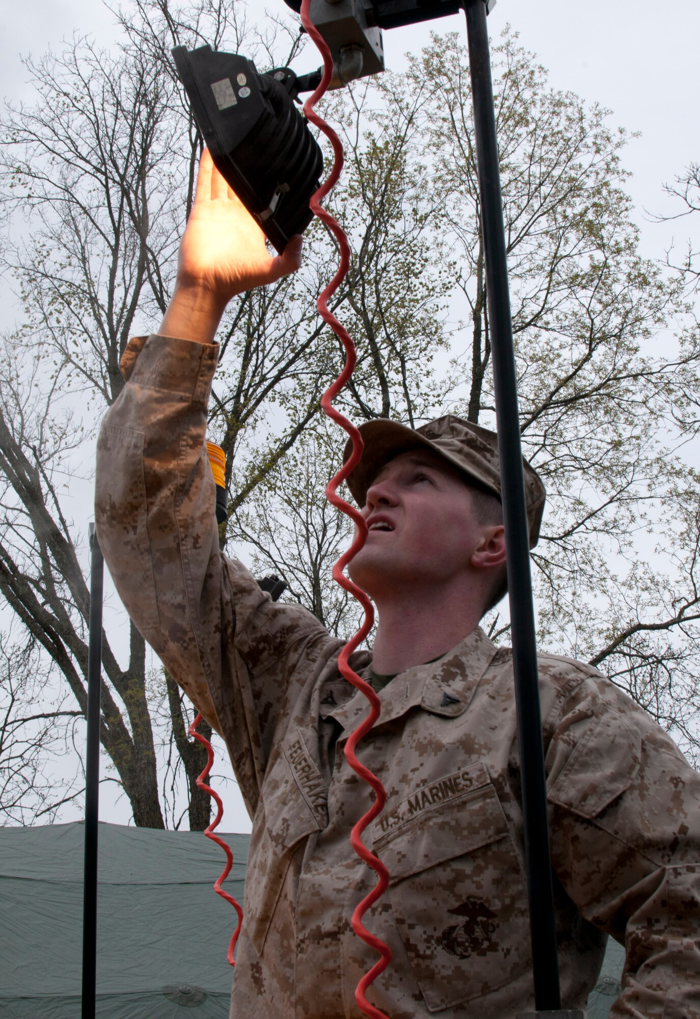 Lance Corporal Tyler Nielson from Marine Wing Support Squadron 471 US Naval- Marine Corps Reserve Readiness Center aims a light while setting up a camp site at William O’Brien Sate Park on the St. Croix River in Minnesota Apr. 13, 2012. Sixteen members of the 208th Weather Flight of the Minnesota Air National Guard, along with three U.S. Marines from the Marine Wing Support Squadron 471 US Naval- Marine Corps Reserve Readiness Center Minneapolis are taking part in a field training exercise. USAF photo by Tech. Sgt. Erik Gudmundson