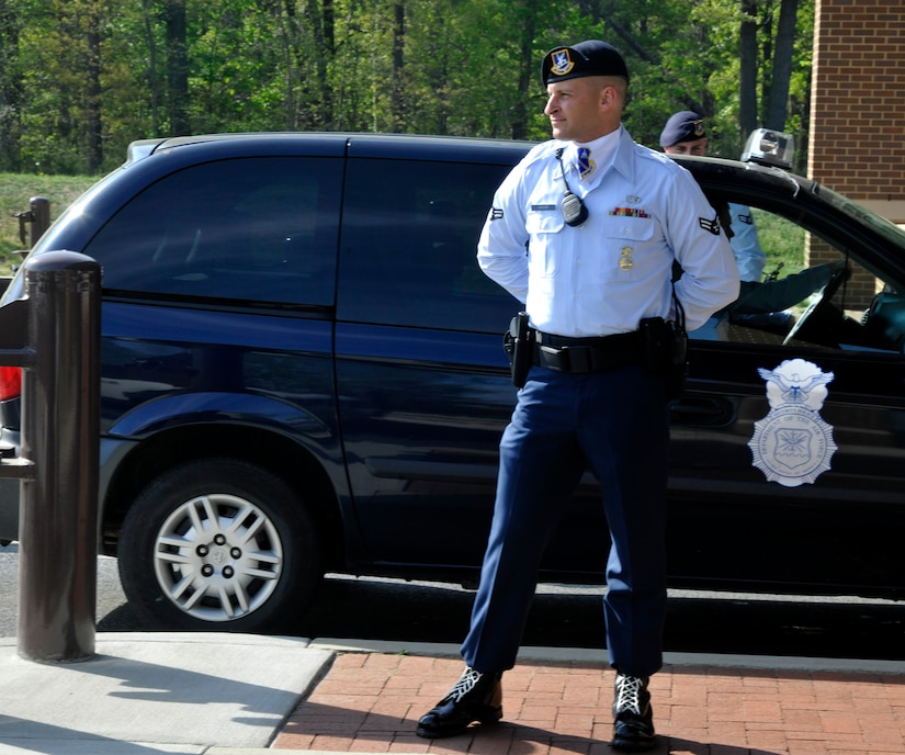 Airman 1st Class Jeffrey Weaver, Andrews Elite Gate Guard, checks IDs and greets Andrews’ morning commuters April 16 on his first duty day as an Elite Gate Guardsman. (U.S. Air Force Photo/Airman 1st Class Lindsey A. Porter)  