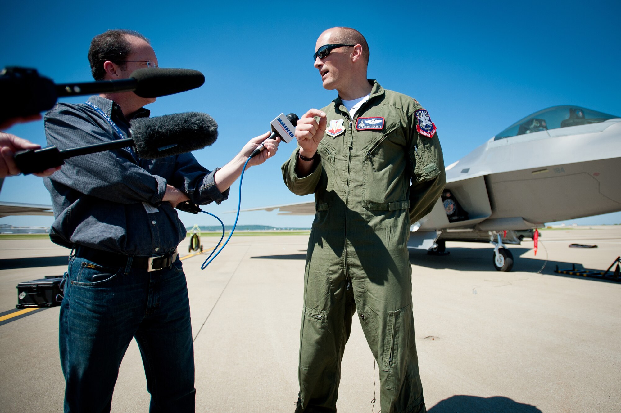 News reporters interview Maj. Henry Schantz, commander of the U.S. Air Force F-22 Raptor Demonstration Team, at the Kentucky Air National Guard Base in Louisville, Ky., on April 18, 2012. Schantz, who is based at Langley Air Force Base, Va., will be piloting the F-22 in Louisville's 22nd annual Thunder Over Louisville air show, to be held along the banks of the Ohio River on April 21. The Raptor is the U.S. military's premier fighter aircraft, with capabilities that are unmatched by any other plane. (U.S. Air Force Photo by Maj. Dale Greer)