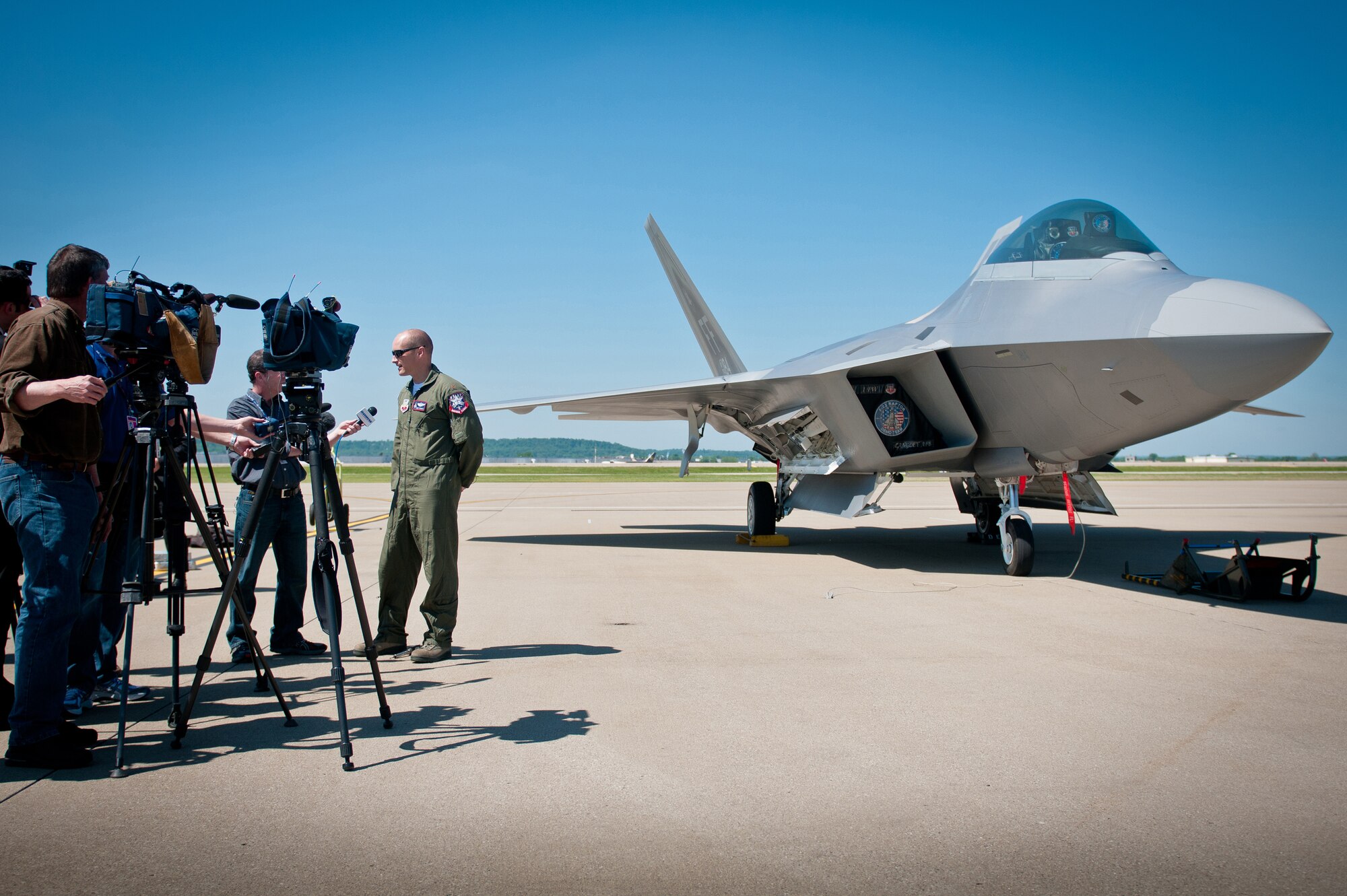 News reporters interview Maj. Henry Schantz, commander of the U.S. Air Force F-22 Raptor Demonstration Team, at the Kentucky Air National Guard Base in Louisville, Ky., on April 18, 2012. Schantz, who is based at Langley Air Force Base, Va., will be piloting the F-22 in Louisville's 22nd annual Thunder Over Louisville air show, to be held along the banks of the Ohio River on April 21. The Raptor is the U.S. military's premier fighter aircraft, with capabilities that are unmatched by any other plane. (U.S. Air Force Photo by Master Sgt.Phil Speck)