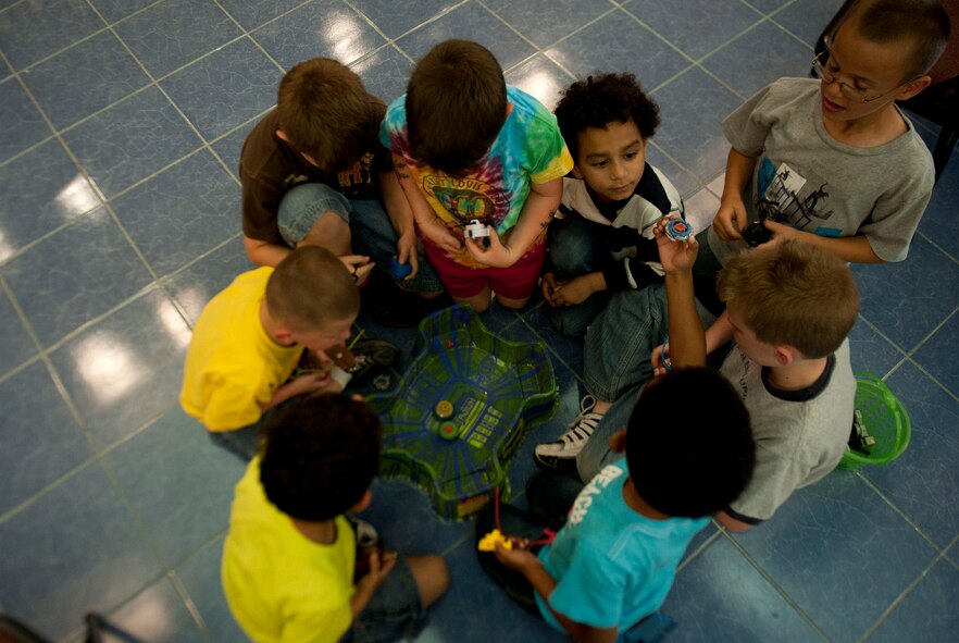 Children play in a side match during the Beyblades Battle Tournament April 18, 2012, at Incirlik Air Base, Turkey. A Beyblade is a spinning top that is launched into an arena with another Beyblade, and the last top spinning wins. The double elimination tournament was open to elementary-age children. The top three competitors in each age bracket received prizes. (U.S. Air Force photo by Senior Airman Clayton Lenhardt/Released)