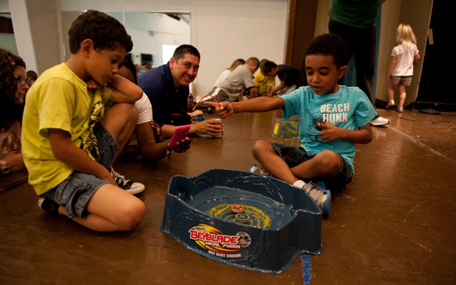 Children compete during the Beyblades Battle Tournament April 18, 2012, at Incirlik Air Base, Turkey. A Beyblade is a spinning top that is launched into an arena with another Beyblade, and the last top spinning wins. The double elimination tournament was open to elementary-age children. The top three competitors in each age bracket received prizes. (U.S. Air Force photo by Senior Airman Clayton Lenhardt/Released)