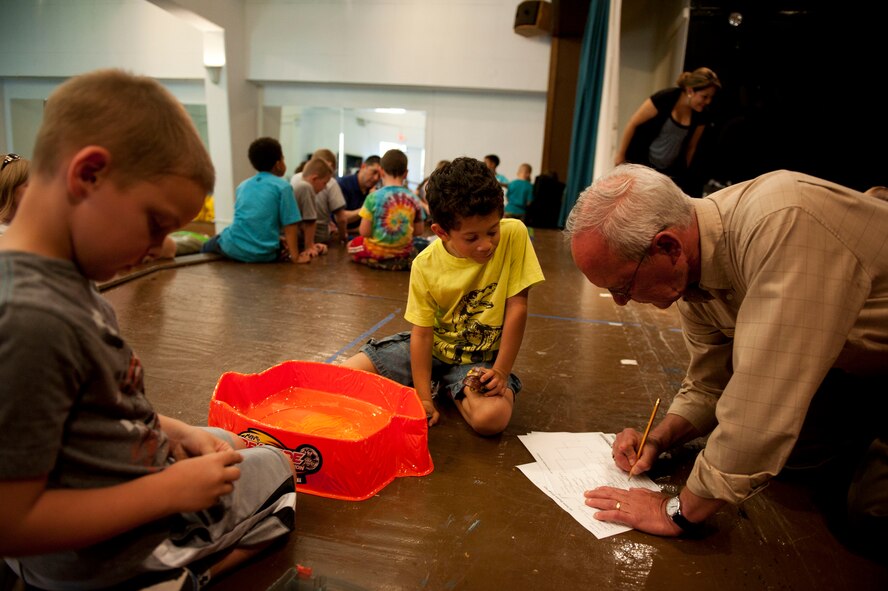 Patrick Curran, community center director, records the outcome of a round during the Beyblades Battle Tournament April 18, 2012, at Incirlik Air Base, Turkey. A Beyblade is a spinning top that is launched into an arena with another Beyblade, and the last top spinning wins. The double elimination tournament was open to elementary-age children. The top three competitors in each age bracket received prizes. (U.S. Air Force photo by Senior Airman Clayton Lenhardt/Released)
