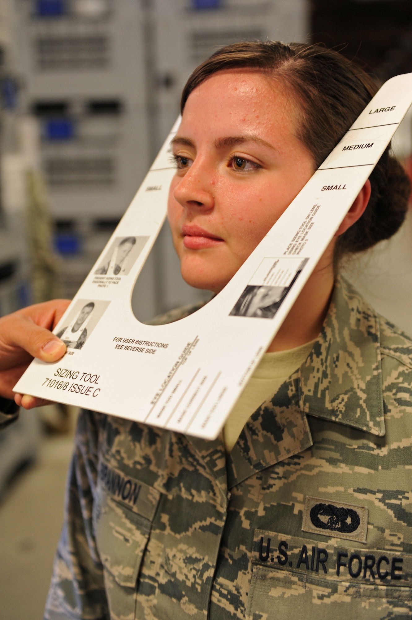 SPANGDAHLEM AIR BASE, Germany – Senior Airmen Pamela Brannon, 52nd Logistics Readiness Squadron passenger travel supervisor, is measured for the size of the gas mask she will be issued with her chemical training gear as part of her in-processing to the base at Bldg. 103 here April 18. The 52nd LRS Material Management Flight Individual Protective Equipment Element maintains, stores and issues IPE used by the 52nd FW. Airmen are issued real-world and training chemical gear, extreme cold weather gear, weapons and other training gear which is used during exercises that test the wing’s ability to protect the base and U.S. government assets during various real-world emergency events. (U.S. Air Force photo by Airman 1st Class Matthew B. Fredericks/Released)