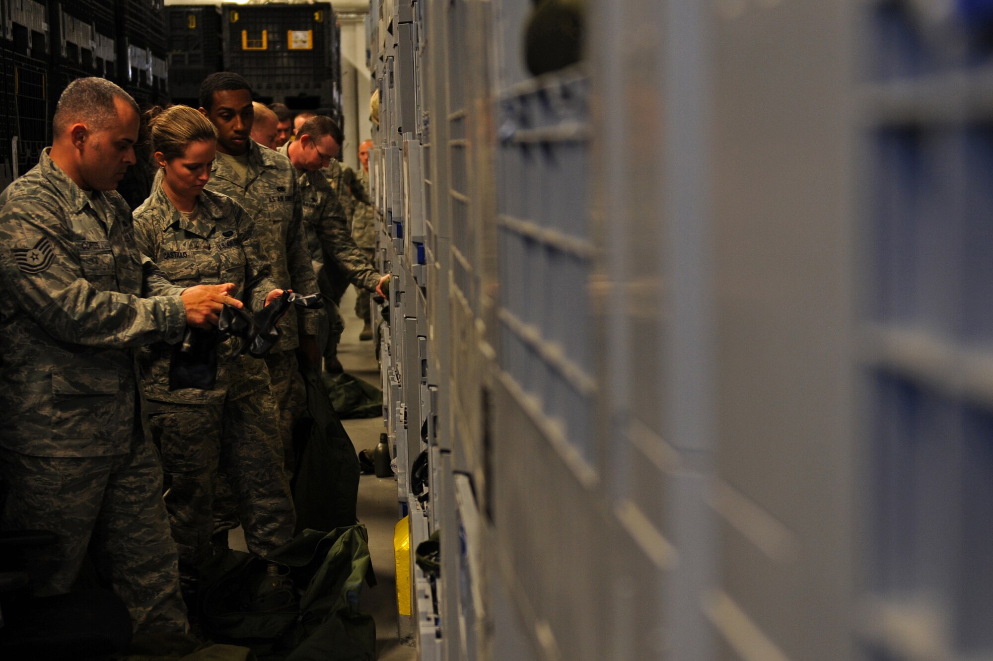 SPANGDAHLEM AIR BASE, Germany – Airmen from the 52nd Fighter Wing gather chemical training gear as part of their in-processing to the base at Bldg. 103 here April 18. The 52nd Logistics Readiness Squadron Material Management Flight Individual Protective Equipment Element maintains, stores and issues IPE used by the 52nd FW. Airmen are issued real-world and training chemical gear, extreme cold weather gear, weapons and other training gear which is used during exercises that test the wing’s ability to protect the base and U.S. government assets during various real-world emergency events. (U.S. Air Force photo by Airman 1st Class Matthew B. Fredericks/Released)