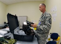 Senior Master Sgt. Michael Hudson, Pacific Air Force Inspector General team member, looks over aircrew chemical defense equipment from the 8th Operations Support Squadron on Kunsan Air Base, Republic of Korea, April 19, 2012. The Wolf Pack is almost halfway through its Consolidated Unit Inspection by the PACAF IG team. (U.S. Air Force photo/Senior Airman Jessica Hines) 