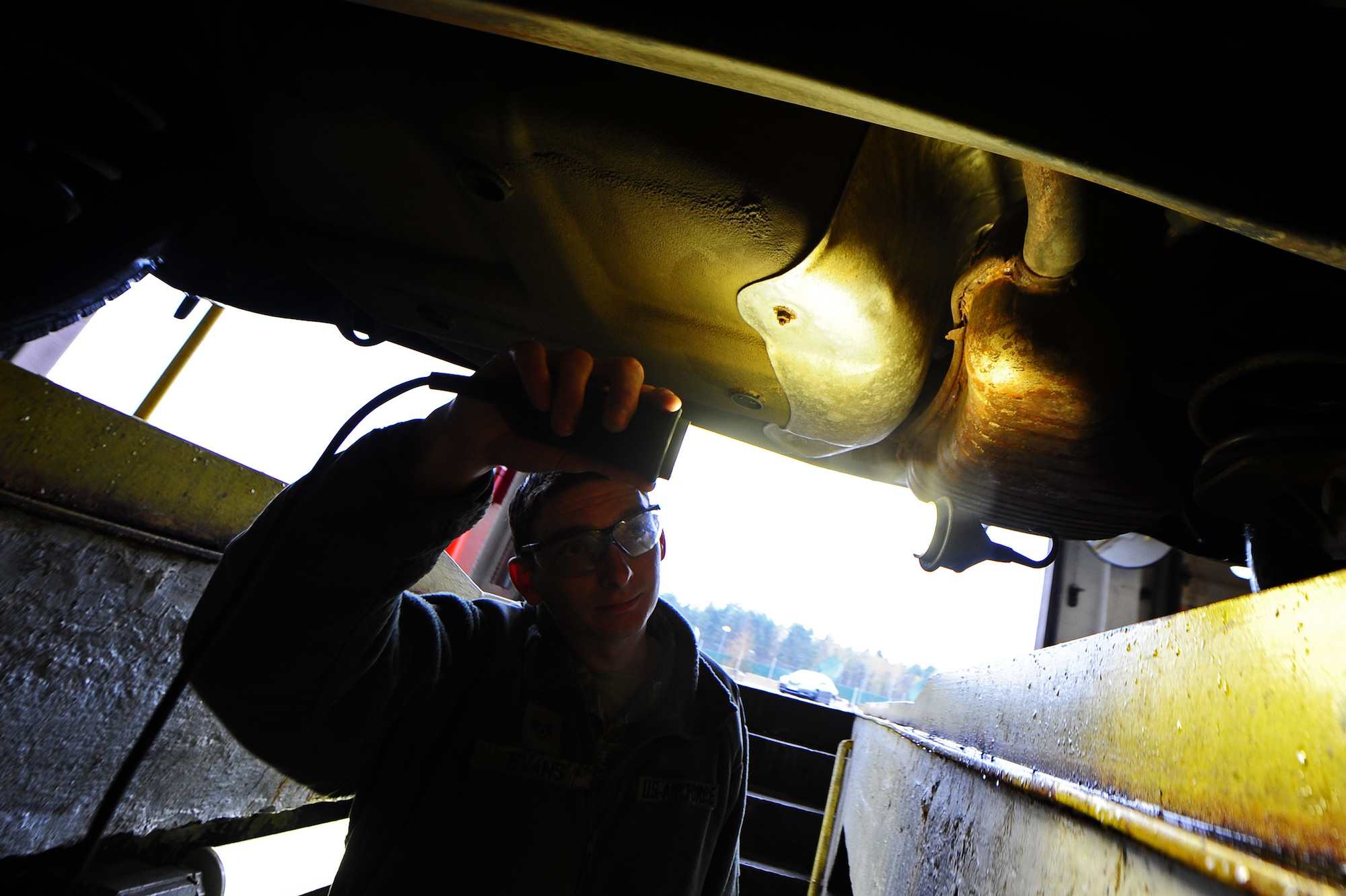 Staff Sgt. John Evans, U.S. Forces Police Squadron, inspects a vehicle for exhaust leaks at the Vehicle Registration Office on Kapaun Air Station, Germany, April 16, 2012. The vehicle registration team serves more than 50,000 people in the Kaiserslautern Military Community. (U.S. Air Force photo/Airman Brea Miller)