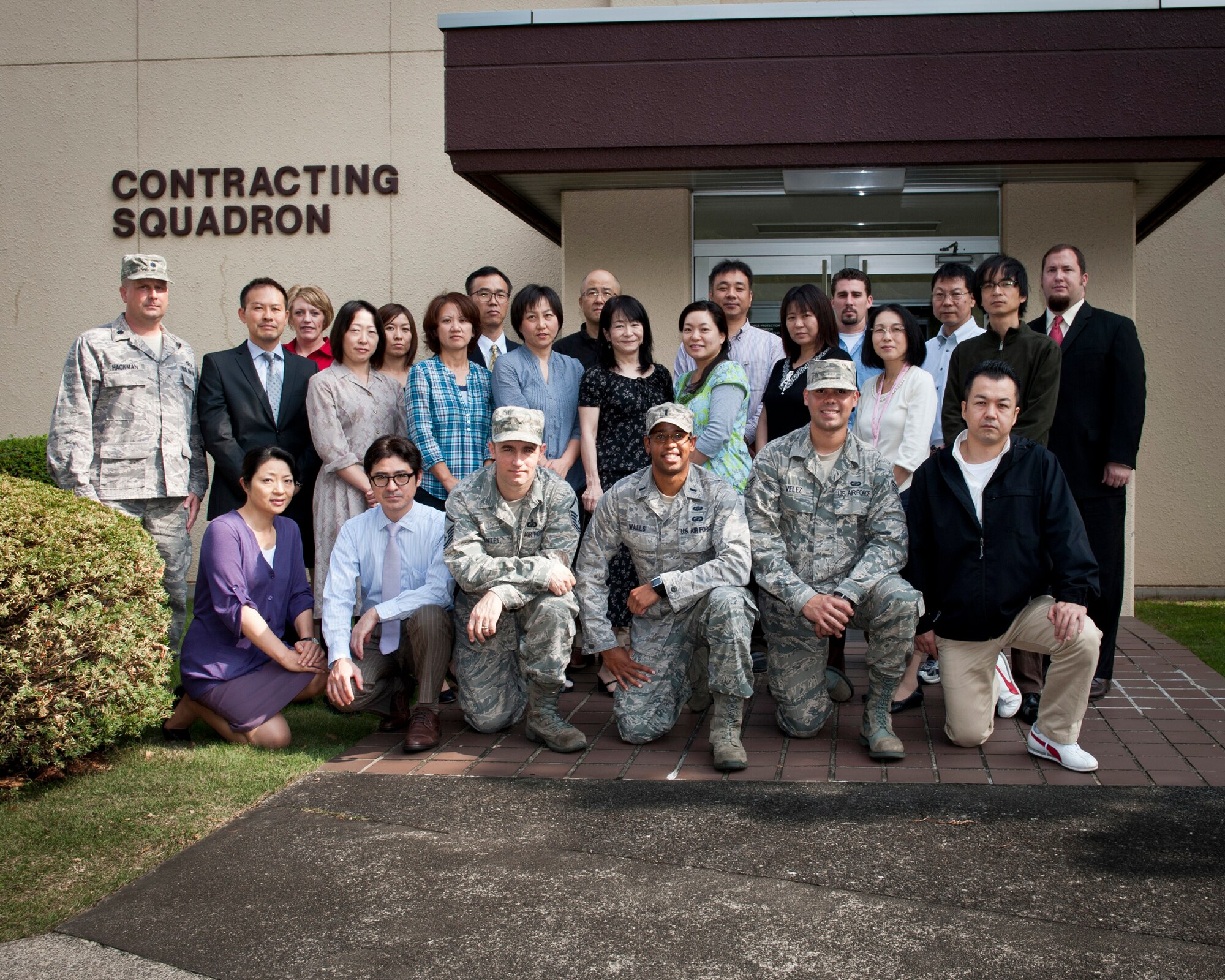 YOKOTA AIR BASE, Japan -- Members of the 374th Contracting Squadron who assisted with Operation Tomodachi pose for a group photo outside their building at Yokota Air Base, Japan, Oct. 25, 2011. The squadron won the Outstanding Contracting Unit Award, large unit, and received the special recognition award for their Operation Tomodachi team for 2011. (U.S. Air Force photo/Staff Sgt. Samuel Morse)
