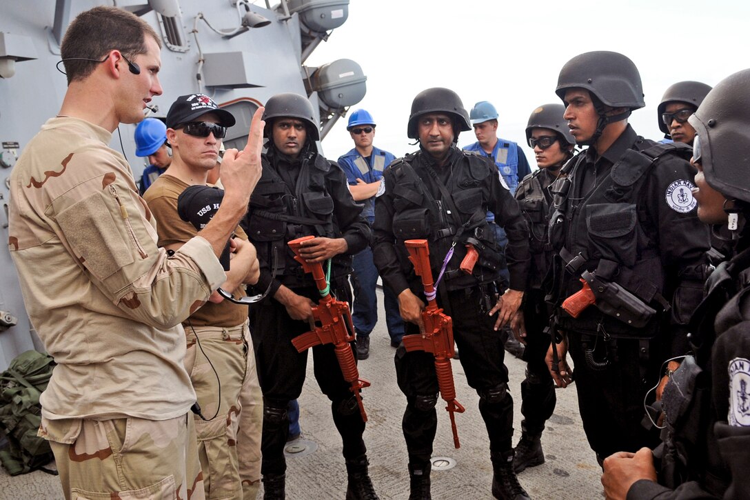U.S. Navy Ensign Timothy Eick briefs Indian sailors at the end of a training exercise aboard the guided-missile destroyer USS Halsey under way in the Indian Ocean, April 12, 2012. 