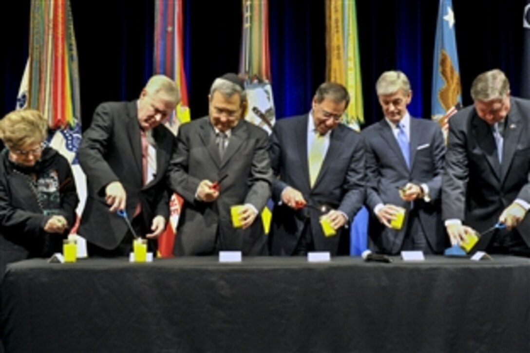 U.S. Defense Secretary Leon E. Panetta, fourth from left, and Israeli Defense Minister Ehud Barak, third from left, light candles during the Holocaust Remembrance Day event at the Pentagon, April 19, 2012. From left to right, Holocaust survivor Charlene Schiff, Navy Secretary Ray Mabus, Army Secretary John M. McHugh and Air Force Secretary Michael B. Donley also participated in the event.