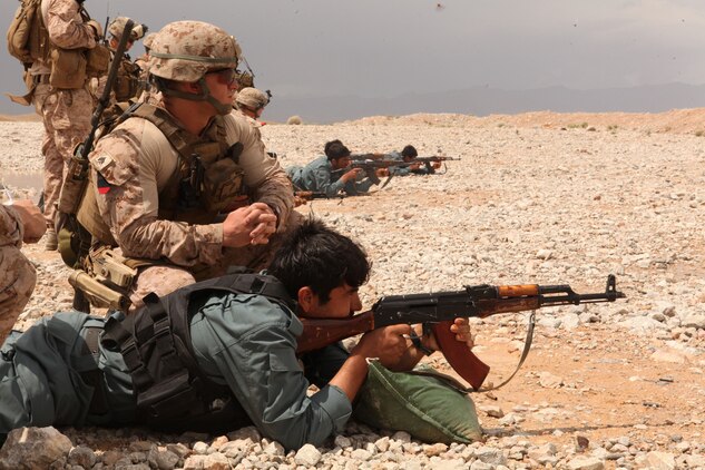 Sergeant Joshua V. Armstrong, team leader serving with 1st Battalion, 8th Marine Regiment, Police Advisory Team 1, coaches an Afghan Uniformed Police officer during a rifle marksmanship range here April 19, 2012. Armstrong, a native of Timber Lake, N.C., and the Marines of the PAT train and work with Afghan Security forces to prepare them to take full responsibility for security operations in the area. (U.S. Marine Corps photo by Lance Cpl. Tyler Reiriz)