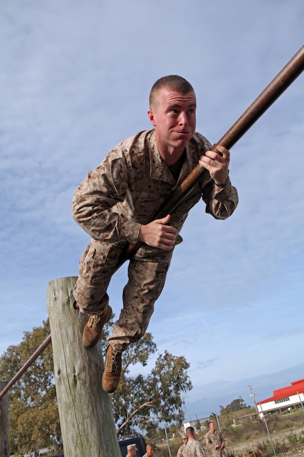 Cpl. Jesse Buhler, an assaultman with Charlie Company, Battalion Landing Team 1st Battalion, 2nd Marine Regiment, 24th Marine Expeditionary Unit,  makes his way across a horizontal bar  on an obstacle course here, April 19, 2012, during a day of training before enjoying time off in Spain. The 24th MEU, partnered with the Navy's Iwo Jima Amphibious Ready Group, is currently deployed as a theater reserve and crisis response force capable of a variety of missions from full-scale combat operations to humanitarian assistance and disaster relief.