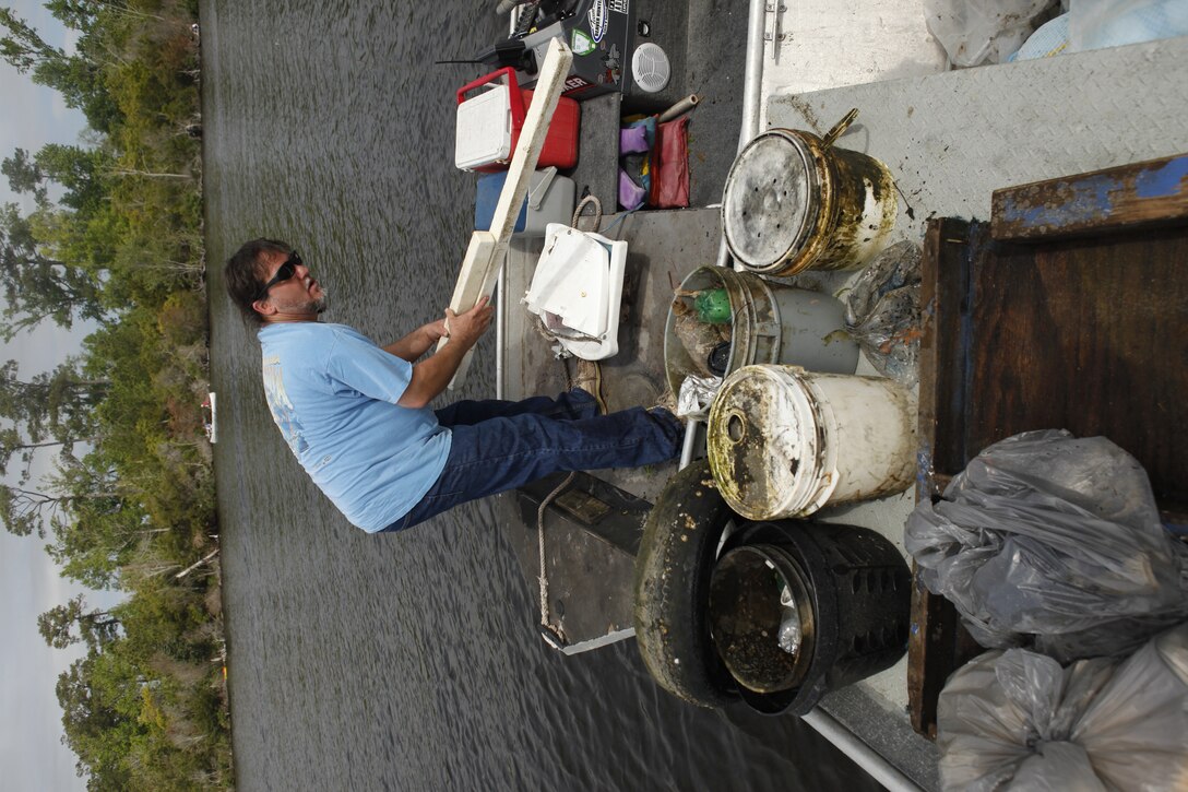 Volunteers unload trash from their boat during the Splash for Trash event held April 20 along the shorelines of Marine Corps Base Camp Lejeune in celebration of Earth Day.