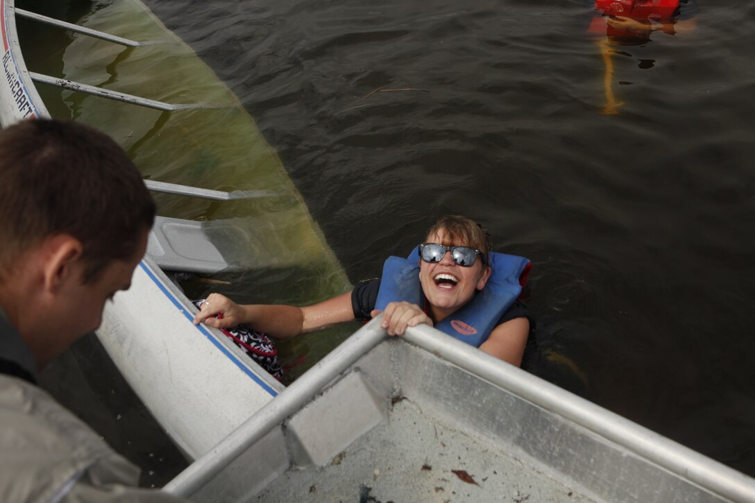 Ashlee Parker, an Earth Day volunteer, laughs after tipping her canoe during the Splash for Trash event held April 20 along the shorelines of Marine Corps Base Camp Lejeune.