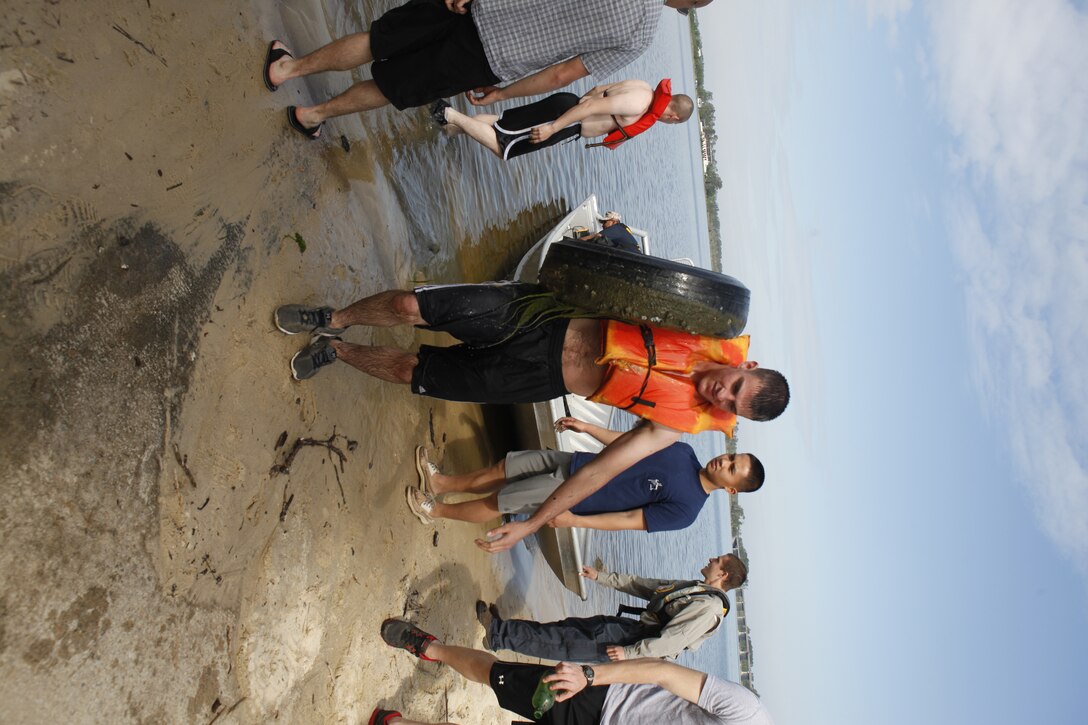 Volunteers unload debris and waste from one of the boats during the Splash for Trash event held April 20 along the shorelines of Marine Corps Base Camp Lejeune in celebration of Earth Day.