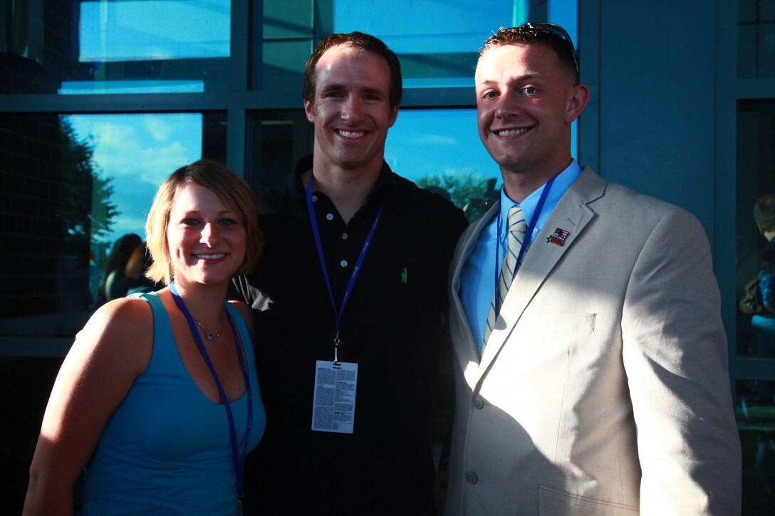 Lance Cpl. Robert J. Hamilton III, right, a patient with the Wounded Warrior Battalion at Marine Corps Base Camp Lejeune, N.C., and his wife, Elizabeth, stand with Drew Brees, quarterback of the New Orleans Saints, April 20, 2012, during the Nicholas Sparks Celebrity Family Weekend in New Bern, N.C. The weekend’s events in downtown New Bern included a celebrity golf tournament, a 5K run, boat tours, a family fun night, silent auction and a screening of Sparks’ new film “The Lucky One.” Proceeds from the weeked events benefit several charities, including Hope For the Warriors, a national non-profit organization dedicated to supporting wounded military members, their families and families of the fallen.