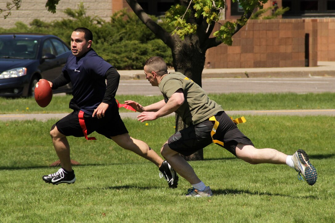 Recruiting Station Twin Cities logistics clerk Sgt. Sergio Lopez evades Sgt. John Treslley, a recruiter out of the Eau Claire, Wis., office, during an all-hands flag football game April 20. For additional imagery from the event, visit www.facebook.com/rstwincities.