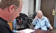 Volunteer Income Tax Assistance Center director, Gabriel Verhage, reviews  information for widow Yoko Ludwig, 84, who stopped at the VITA Center April 13 to file her tax returns before the April 17 deadline. Based on her information, Verhage determined she was not required to file a return. The services provided by the VITA Center were free for all military, dependents, retirees, Defense Department civilians or anyone with legal access to March Air Reserve Base. (U.S. Air Force photo by Tech. Sgt. Joe Davidson)
