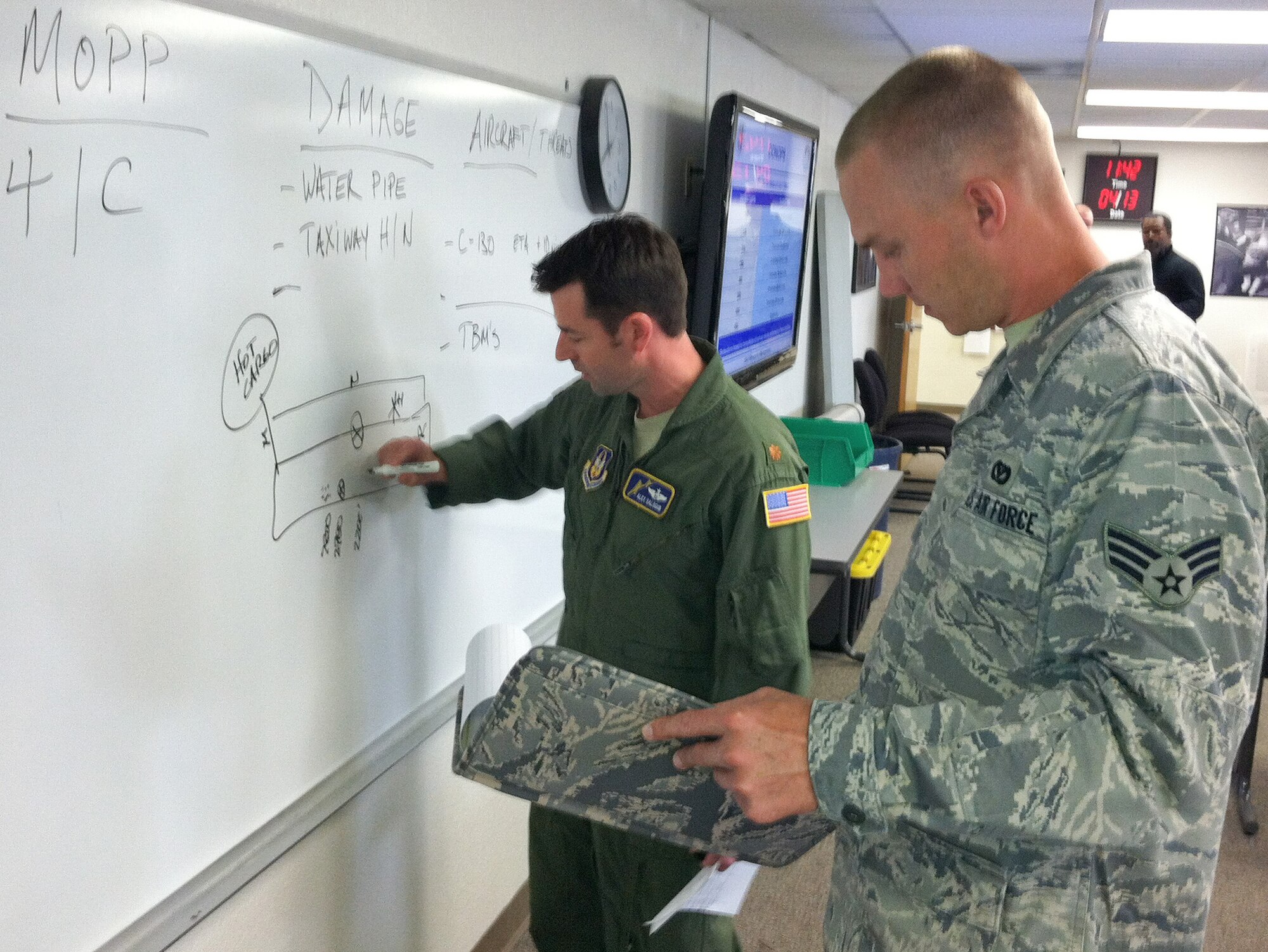 Maj. Alex Salogub (left), Chief of Tactics for the 349th Operations Support
Flight and Senior Airman Michael J. Wade, engineering assistant with the
349th Civil Engineering Squadron, assess simulated runway battle damage
during table-top training for the Crisis Action Team and the Wing Operations
Center at Travis Air Force Base, Calif., April 13, 2012. The training is in
preparation for next month's Operational Readiness Exercise.  (U.S. Air
Force photo / Lt. Col. Robert Couse-Baker)
