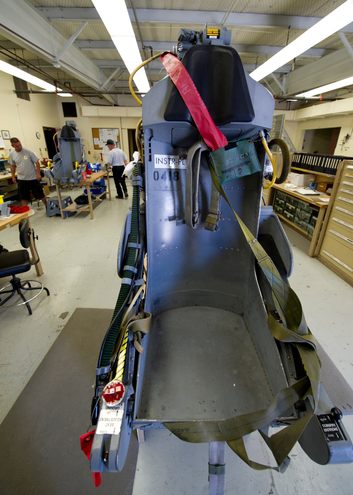 HOLLOMAN AIR FORCE BASE, N.M. – Aircraft egress mechanics for the T-38 Talon perform maintenance on ejection seats April 19. Each seat is composed of a system of small explosives that ensure the seat will launch out of the aircraft.  Egress mechanics are responsible for maintaining critical equipment that could save a pilot’s life in the event of an emergency. (U.S. Air Force photo by Daniel E. Liddicoet/Released)