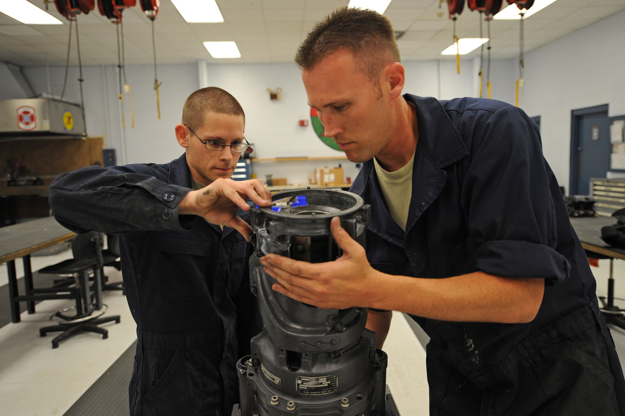 U.S. Air Force Senior Airman Joshua Walk (left) and Staff Sgt. Jeremy Coppock disassemble a M61-A1 20mm gatling gun during an inspection on Seymour Johnson Air Force Base, N.C., April 19, 2012. During inspection, the weapon is checked for wear and tear, corrosion, and specific rounds fired. Walk, 4th Equipment Maintenance Squadron aircraft armament systems journeyman, hails from State College, Pa. Coppock, 4th Equipment Maintenance Squadron aircraft armament systems craftsman, is from Tuscon, Ariz. (U.S. Air Force photo/Airman 1st Class John Nieves Camacho/Released)