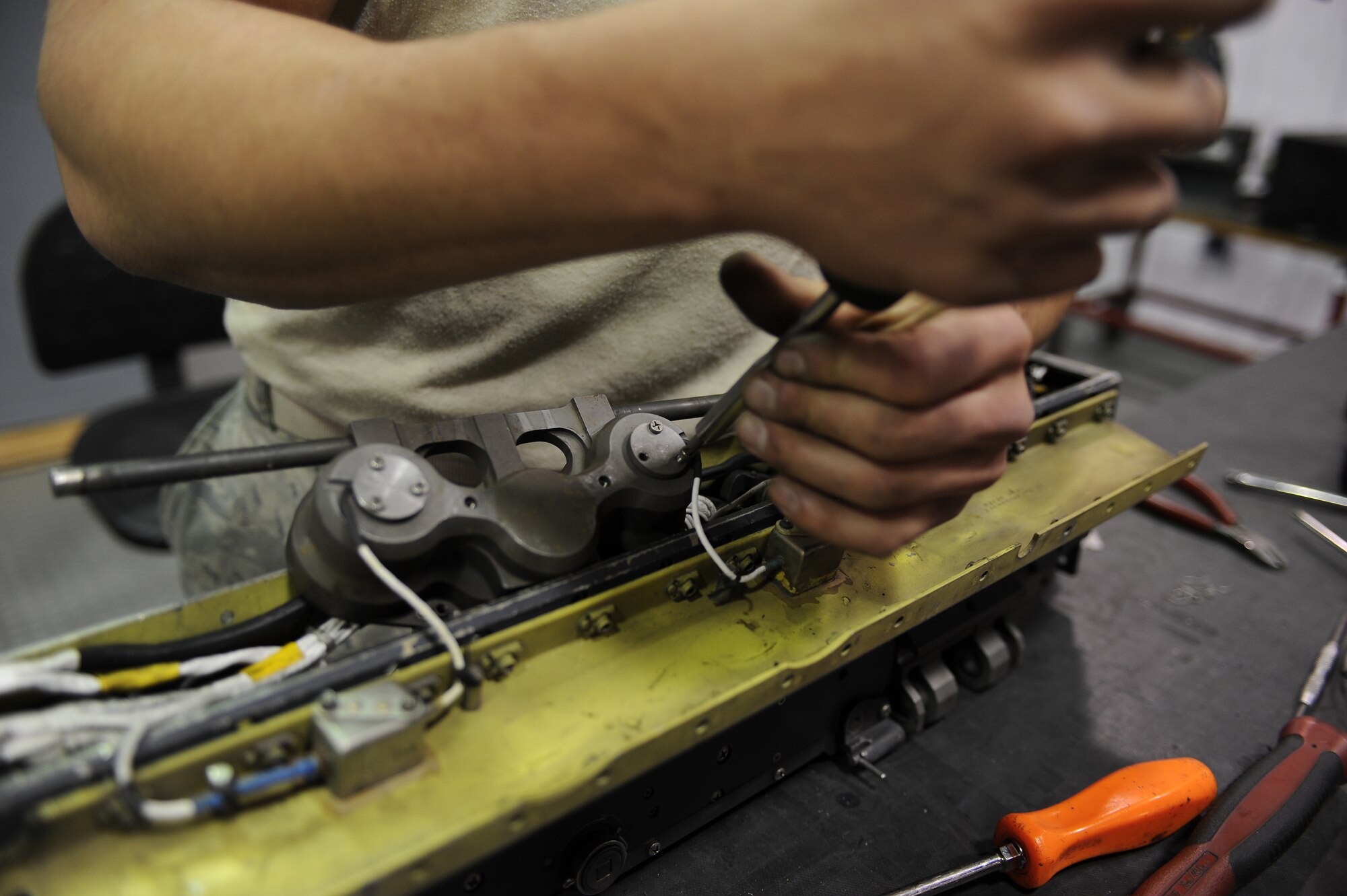 U.S. Air Force Senior Airman William Tylor unscrews a breech contact on a bomb release unit 47 at the armament shop on Seymour Johnson Air Force Base, N.C., April 19, 2012. The breech contact provides electrical power to set off the impulse cart when deploying bombs. Tylor, 4th Equipment Maintenance Squadron aircraft armament systems journeyman, is from Owings, Md. (U.S. Air Force photo/Airman 1st Class John Nieves Camacho/Released)
