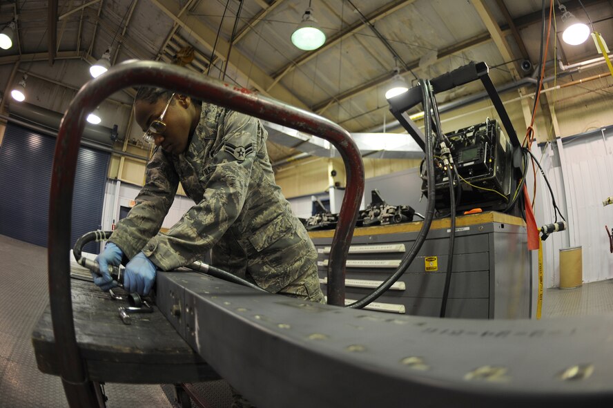 U.S. Air Force Airman 1st Class Charlene Hogans connects a power cable from a tester into a launcher adapter unit 128 at the armament shop on Seymour Johnson Air Force Base, N.C., April 19, 2012. The tester acts as a power source for the LAU-128 to ensure proper function. Hogans, 4th Equipment Maintenance Squadron aircraft armament systems apprentice, hails from Chicago. (U.S. Air Force photo/Airman 1st Class John Nieves Camacho/Released)