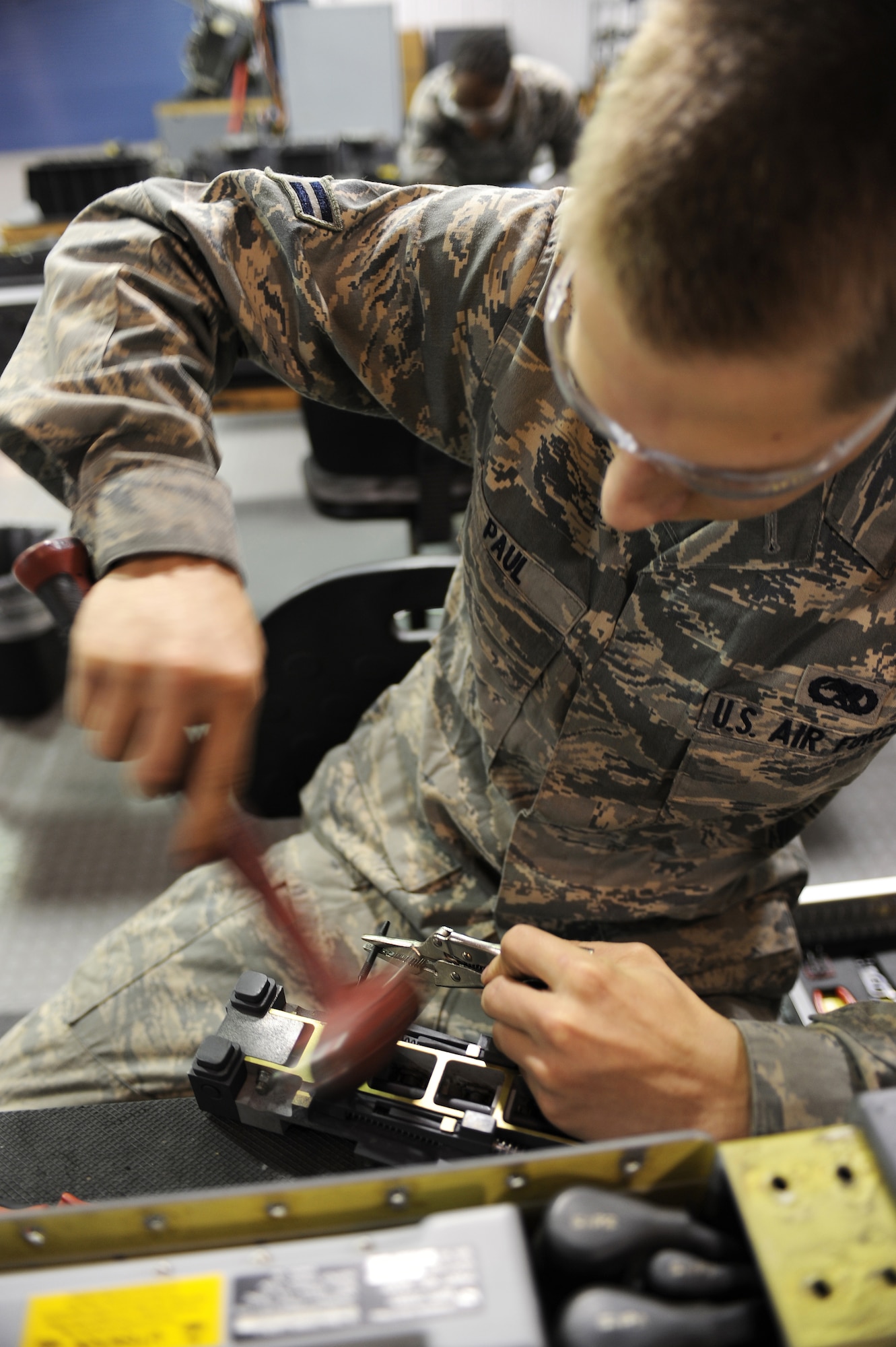 U.S. Air Force Airman 1st Class Jordan Paul hammers a punch to remove a pin on an AFT-dampener assembly at the armament shop on Seymour Johnson Air Force Base, N.C., April 19, 2012. The AFT-dampener ensures that missiles will remain latched onto the launcher adapter unit 128. Paul, 4th Equipment Maintenance Squadron aircraft armament systems apprentice, is from Kelly, La. (U.S. Air Force photo/Airman 1st Class John Nieves Camacho/Released)