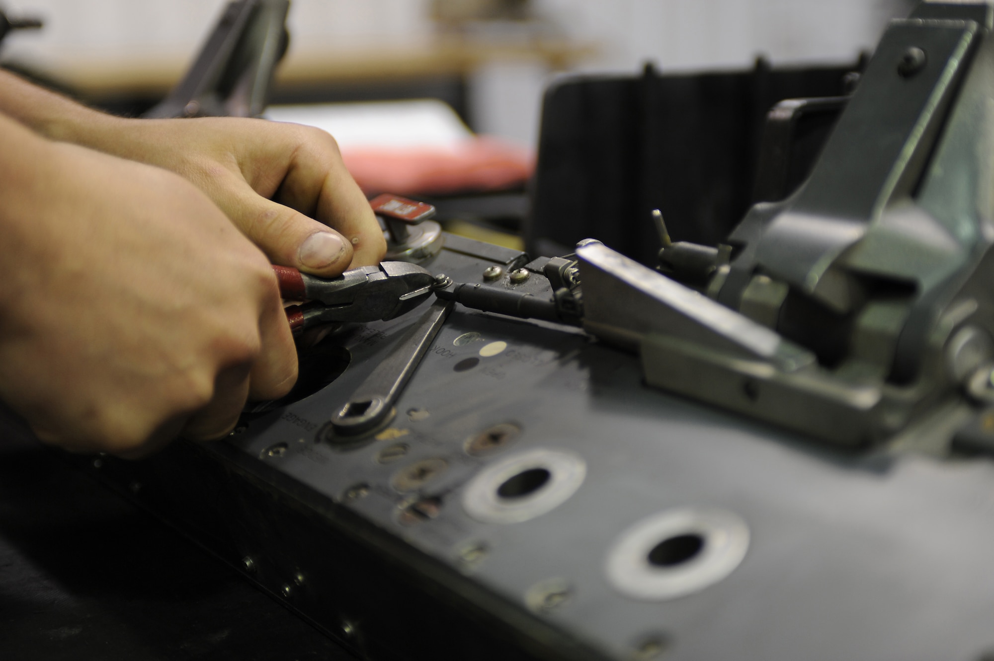 U.S. Air Force Senior Airman William Tylor removes a swedge from a bomb release unit 47 bomb rack at the armament shop on Seymour Johnson Air Force Base, N.C., April 19, 2012. The BRU-47 holds and dispenses bombs with a total ejection force of 22,000 pounds. Tylor, 4th Equipment Maintenance Squadron aircraft armament systems journeyman, is from Owings, Md. (U.S. Air Force photo/Airman 1st Class John Nieves Camacho/Released)