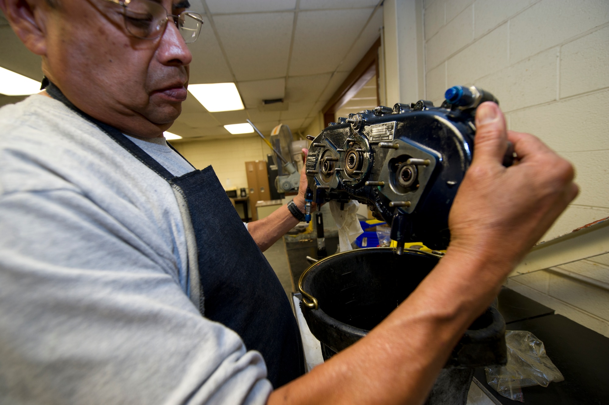 HOLLOMAN AIR FORCE BASE, N.M. – Bobby Aguilar, an aircraft engine mechanic for the T-38 Talon, cleans an engine-mounting gear box on the J85 jet engine April 19. Aguilar works in the accessories section of the T-38 engine shop. His job is to clean and prepare specific parts for reassembly. (U.S. Air Force photo by Daniel E. Liddicoet/Released)