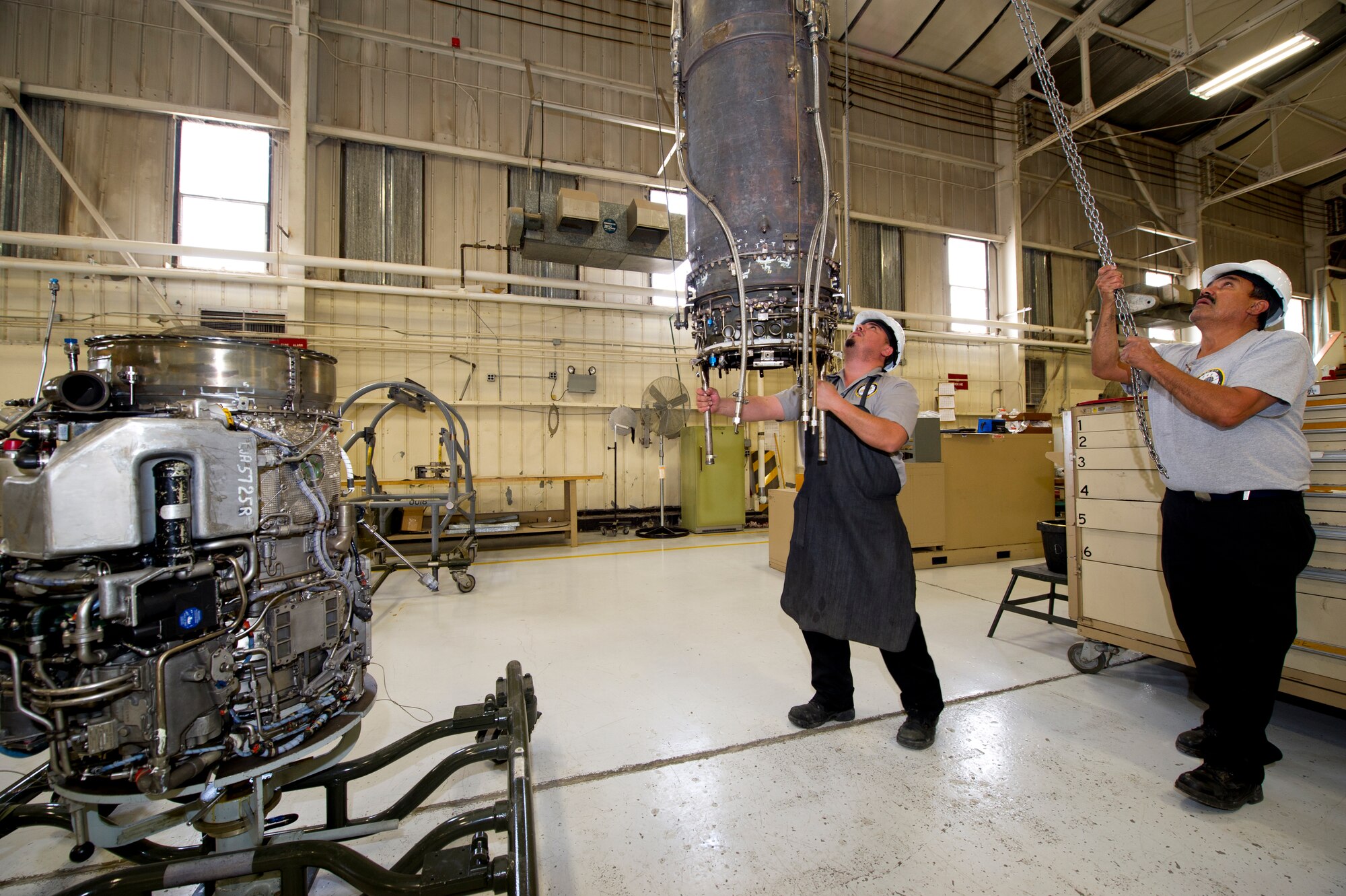 HOLLOMAN AIR FORCE BASE, N.M. – Aircraft engine mechanics for the T-38 Talon separate a J85 jet engine April 19. The J85 is a small, single-shaft turbojet engine capable of producing up to 3,000 pounds of thrust. The engine is lightweight and cost-efficient, making it ideal for training at Holloman AFB. (U.S. Air Force photo by Daniel E. Liddicoet/Released)