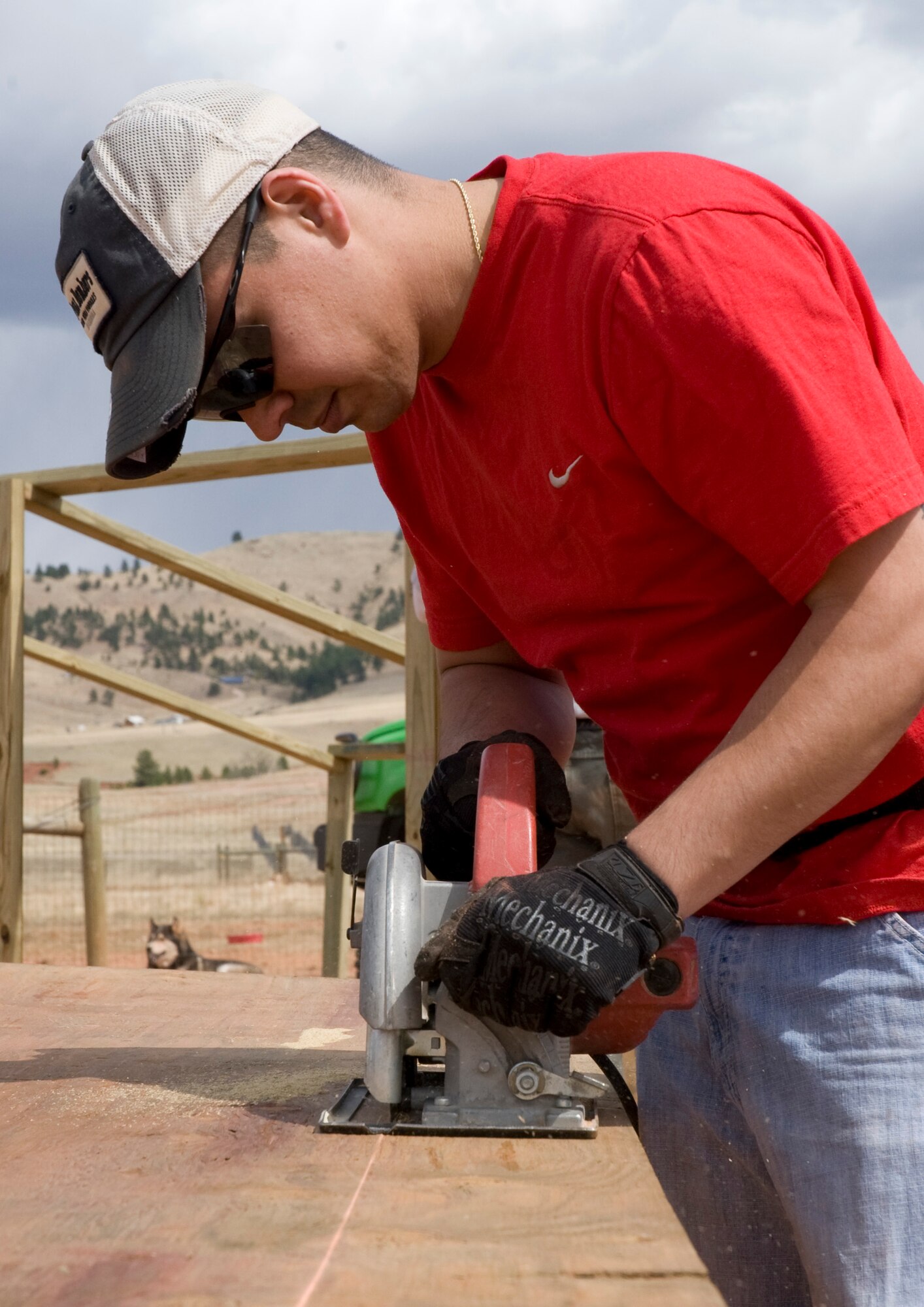 Staff Sgt. Richard Colon, 28th Civil Engineer Squadron water fuels maintenance craftsman, uses a power saw to cut wood during construction of a new temporary animal shelter for the Battle Humane Society in Hot Springs, S.D., April 13, 2012. Colon teamed up with several other Ellsworth Airmen who volunteered their time and skills to build several new shelters for the animals that lost their home in a fire. (U.S. Air Force photo by Airman 1st Class Anania Tekurio/Released)