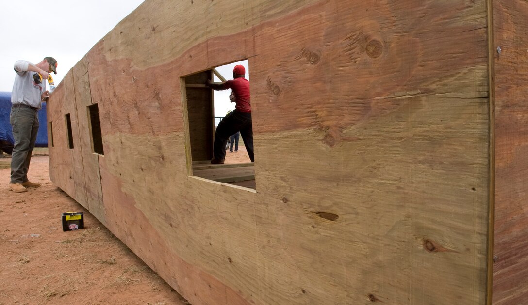 Tech. Sgt. Joshua Hallmark and Staff Sgt. Santana Brown, 28th Civil Engineer Squadron structures craftsmen, build a new temporary shelter for the animals at the Battle Mountain Humane Society in Hot Springs, S.D., April 13, 2012. The Battle Mountain Humane Society, a privately-owned, no-kill shelter for animals, has been taking in and caring for animals for the last five years.  (U.S. Air Force photo by Airman 1st Class Anania Tekurio/Released)