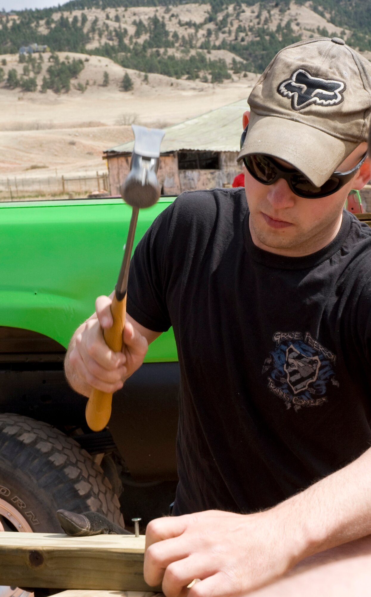 Airman 1st Class Anthony Russell, 28th Civil Engineer Squadron water fuels maintenance apprentice, hammers a nail into the new temporary shelter for the animals at Battle Mountain Humane Society in Hot Springs, S.D., April 13, 2012. Russell teamed up with several other Ellsworth Airmen who volunteered their time and skills to build several new shelters for the animals that lost their home in a fire. (U.S. Air Force photo by Airman 1st Class Anania Tekurio/Released)