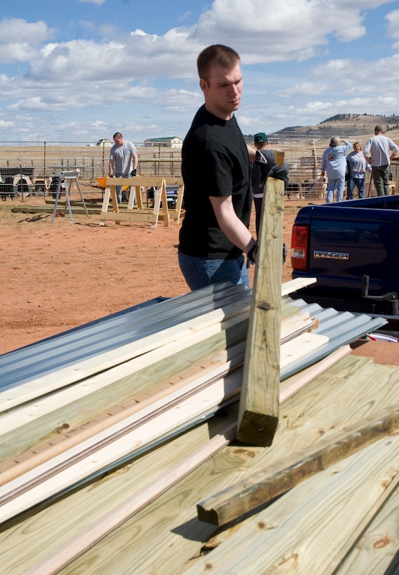 Airman 1st Class David Loving, 28th Civil Engineer Squadron structures apprentice, unloads building materials during the construction of a new temporary animal shelter at the Battle Mountain Humane Society in Hot Springs S.D., April 13, 2012.  Ten Airmen from Ellsworth Air Force Base, S.D, volunteered their time and energy to help build several new structures for the animals who lost their home in the fire. (U.S. Air Force photo by Airman 1st Class Anania Tekurio/Released)