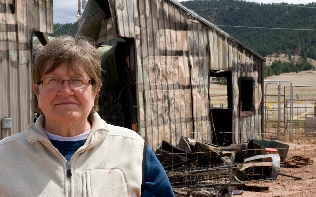 Tonia Wagner, Battle Mountain Humane Society owner, stands by the remains of her apartment and the animal shelter that were destroyed in a fire at the Battle Mountain Humane Society in Hot Springs S.D., April 13, 2012. Wagner has dedicated her life to providing care and shelter to animals in need.  (U.S. Air Force photo by Airman 1st Class Anania Tekurio/Released)