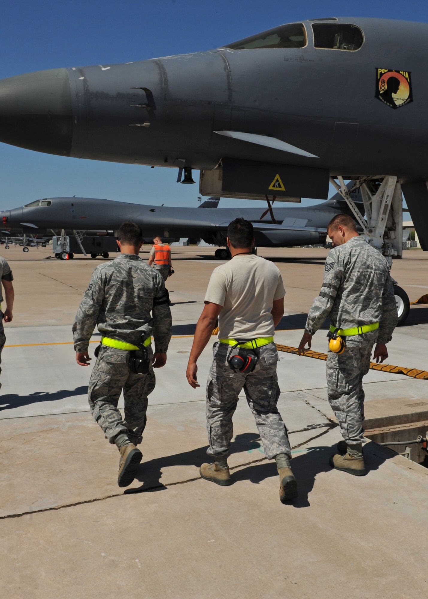Airmen from the 7th Aircraft Maintenance Squadron conduct a Foreign Object Debris walk during shift change April 18, 2012, at Dyess Air Force Base, Texas. FOD is any substance, debris or article alien to a vehicle or system which can cause significant damage. FOD walks are conducted to minimize possible damage to aircraft from debris. (U.S. Air Force photo by Airman 1st Class Peter Thompson/ Released)