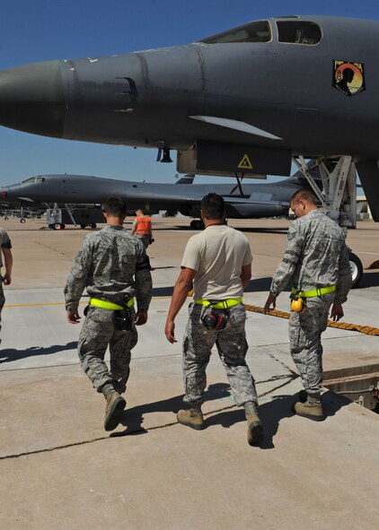 Airmen from the 7th Aircraft Maintenance Squadron conduct a Foreign Object Debris walk during shift change April 18, 2012, at Dyess Air Force Base, Texas. FOD is any substance, debris or article alien to a vehicle or system, which can cause significant damage. FOD walks are conducted to minimize possible damage to aircraft from debris. (U.S. Air Force photo by Airman 1st Class Peter Thompson/ Released) 

