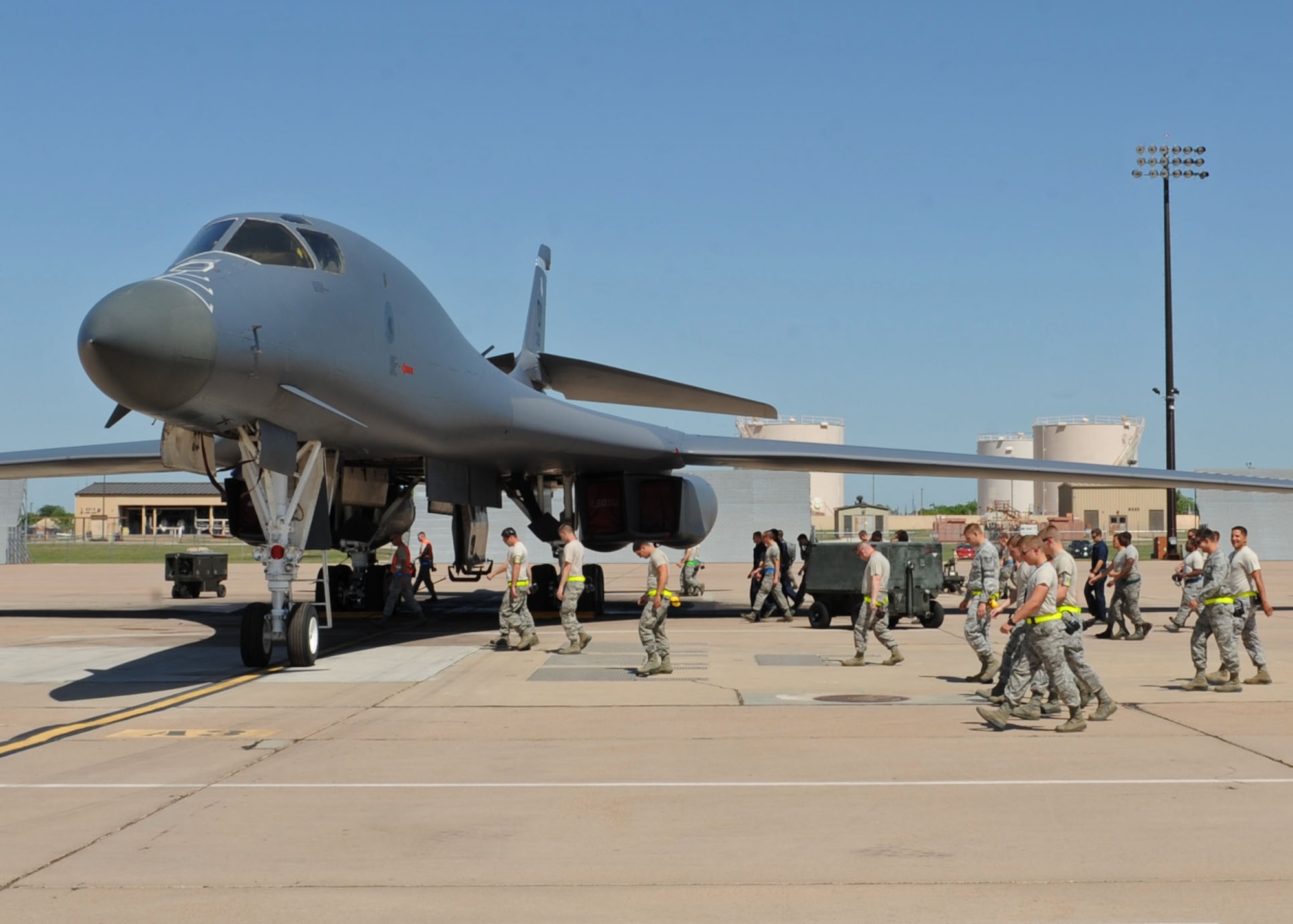 Airmen from the 7th Aircraft Maintenance Squadron conduct a Foreign Object Debris walk during shift change April 18, 2012, at Dyess Air Force Base, Texas. FOD is any substance, debris or article alien to a vehicle or system which can cause significant damage. FOD walks are conducted to minimize possible damage to aircraft from debris. (U.S. Air Force photo by Airman 1st Class Peter Thompson/ Released)